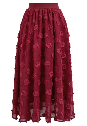 Jupe mi-longue élastique à pois et pompons en rouge